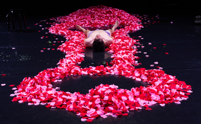 Performer leži v penisu iz cvetnih lističev.